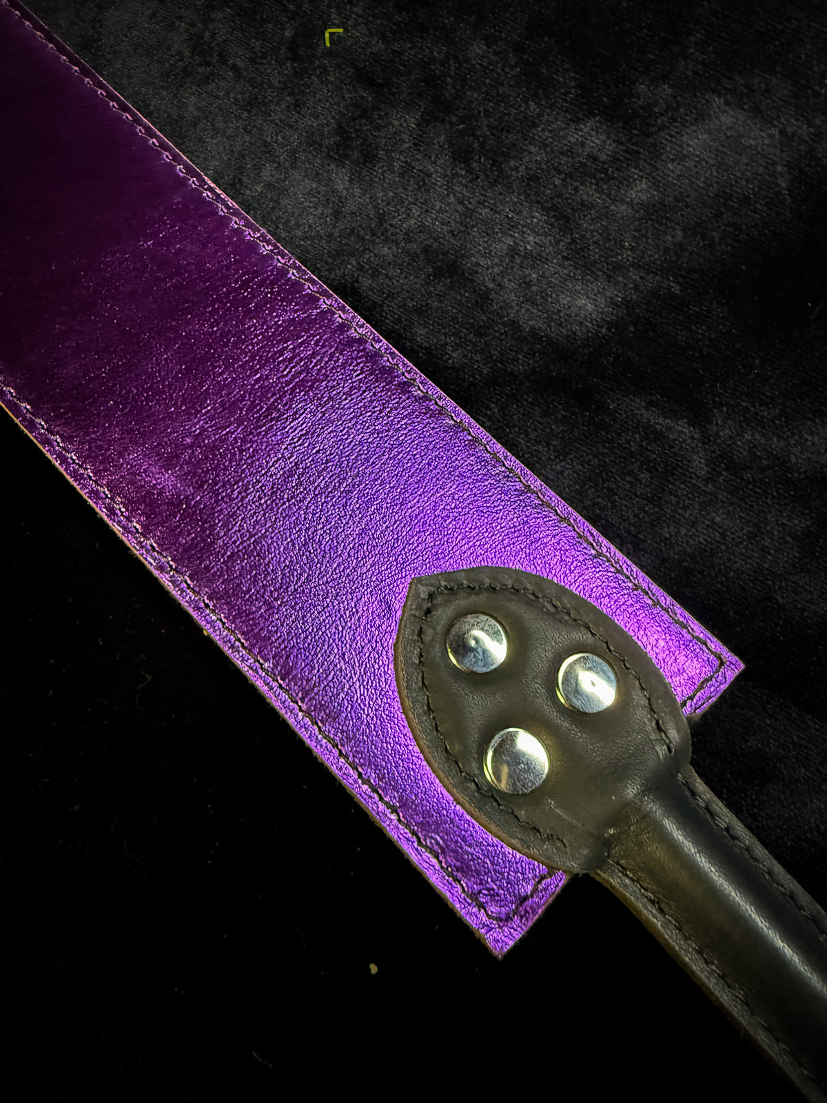 Brown and purple leather flapper paddle, detail