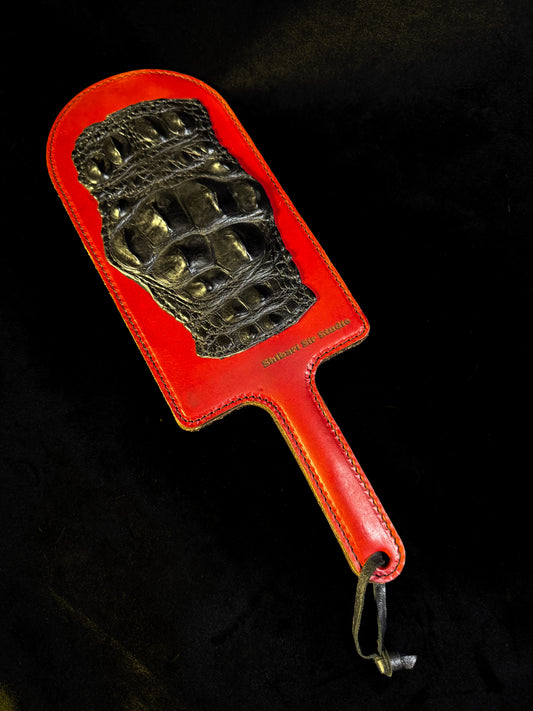 Red leather paddle with black crocodile inlay, handmade in Australia