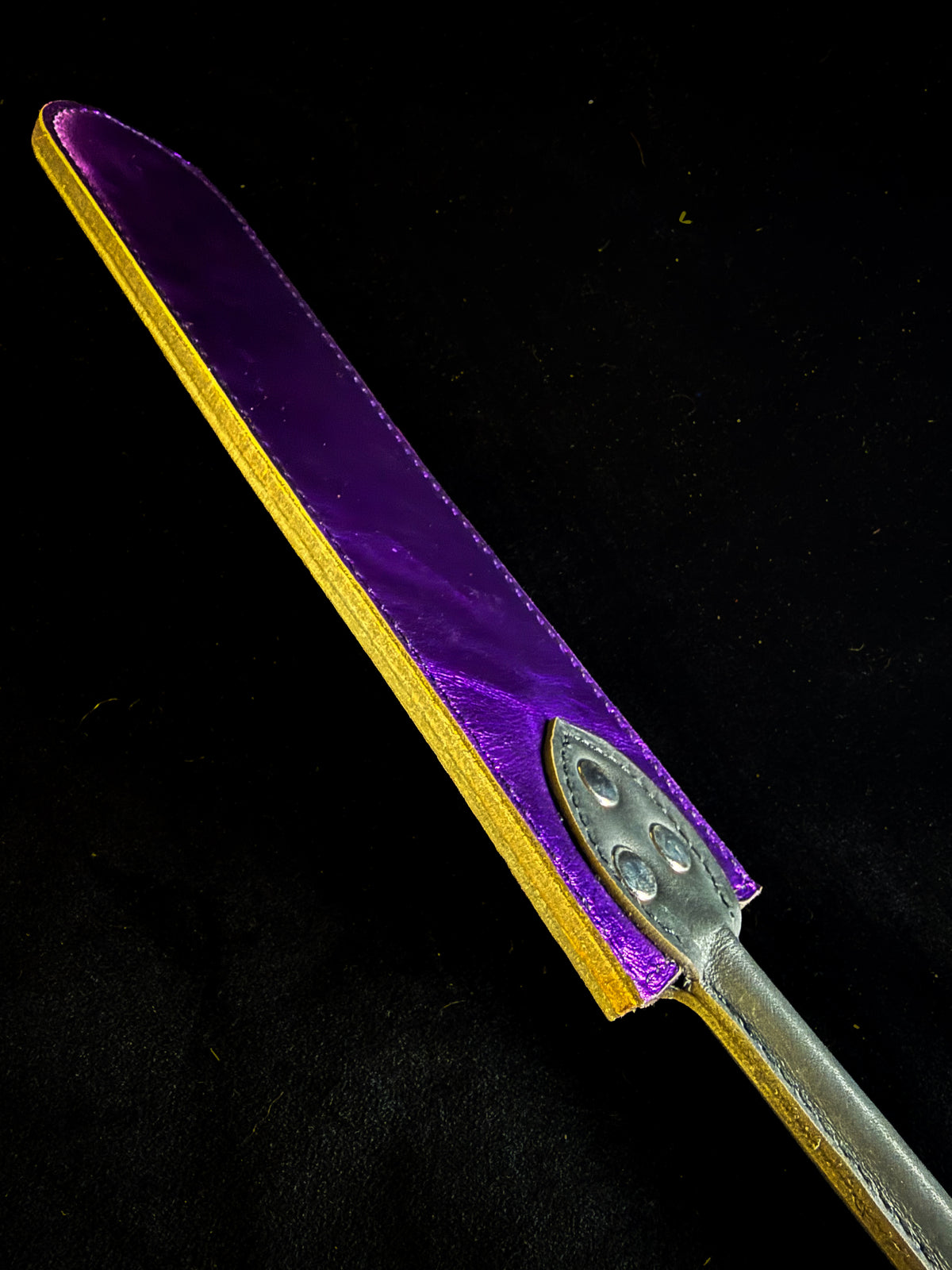 Brown and purple leather flapper paddle, detail
