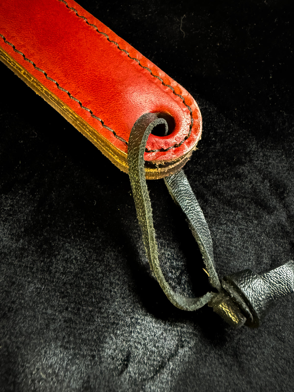Red leather paddle with black crocodile inlay, detail